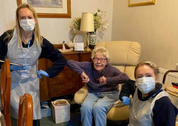 June Newton after getting her Covid vaccine from Louise Lydon, left and Laura Rowley, right.