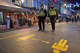 File photo dated 04/12/20 of police officers on patrol around cafes and pubs in Cardiff. Nine Metropolitan Police officers have been fined ??200 each for breaching Covid-19 regulations for eating in a cafe while on duty, Scotland Yard has said. PA Photo. Issue date: Wednesday January 20, 2021. The officers, members of the South East Basic Command Unit, were investigated after images of them in uniform eating together were posted online earlier this month. See PA story POLICE Fines. Photo credit should read: Ben Birchall/PA Wire 