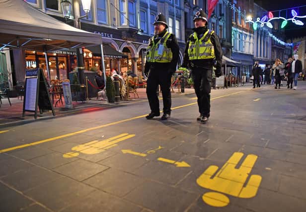 File photo dated 04/12/20 of police officers on patrol around cafes and pubs in Cardiff. Nine Metropolitan Police officers have been fined ??200 each for breaching Covid-19 regulations for eating in a cafe while on duty, Scotland Yard has said. PA Photo. Issue date: Wednesday January 20, 2021. The officers, members of the South East Basic Command Unit, were investigated after images of them in uniform eating together were posted online earlier this month. See PA story POLICE Fines. Photo credit should read: Ben Birchall/PA Wire