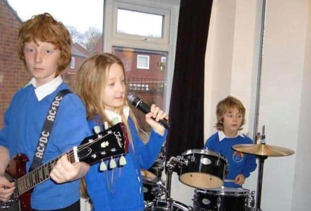 Eve with brothers Luke (left) and Jake in the band's early days.