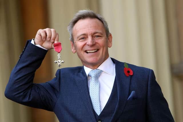 Former Newcastle United defender John Beresford with his MBE at Buckingham Palace in 2017.