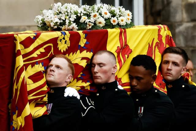 Pallbearers carrying the coffin of Queen Elizabeth II, draped with the Royal Standard of Scotland, as it arrives at Holyroodhouse, Edinburgh, where it will lie in rest for a day. Picture date: Sunday September 11, 2022.