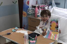 Children's Heart Unit patient Faith with her sewing magazine and new tablet bought through then charity's coronavirus fund to entertain her whilst in hospital isolation.