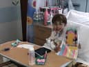 Children's Heart Unit patient Faith with her sewing magazine and new tablet bought through then charity's coronavirus fund to entertain her whilst in hospital isolation.