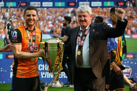 Alex and Steve Bruce lift the Championship play-off final trophy with Hull.