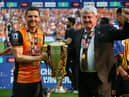 Alex and Steve Bruce lift the Championship play-off final trophy with Hull.