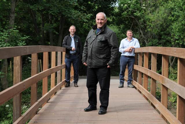 South Tyneside Council Cllr Ernest Gibson with ESH Civil's Steve Marshall and Stephen McClean on the newly installed bridge over the River Don at Mill Dene, Primrose, Jarrow.