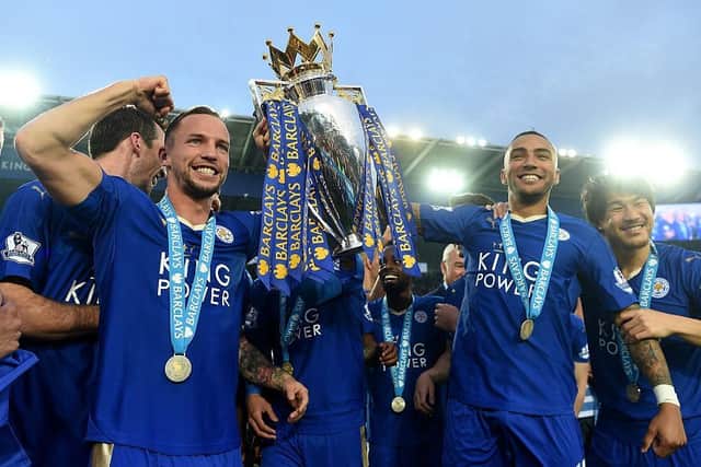 Danny Drinkwater and Danny Simpson of Leicester City poses with the Premier League Trophy as players and staffs celebrate the season champion after the Barclays Premier League match between Leicester City and Everton at The King Power Stadium on May 7, 2016 in Leicester, United Kingdom.  (Photo by Michael Regan/Getty Images)