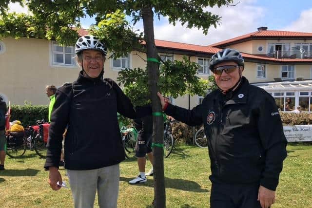 Tom Fennelly (right) and Wolfgang Mohrhenn (left) pictured on the last visit in 2019 at the Green Route Oak Tree of Friendship planted outside the Littlehaven Hotel in 1999 to mark the start/finish of the Green Route between the twin towns.