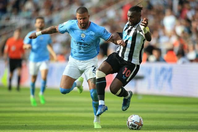 Manchester City's English defender Kyle Walker (L) fights for the ball with Newcastle United's French midfielder Allan Saint-Maximin during the English Premier League football match between Newcastle United and Manchester City at St James' Park in Newcastle-upon-Tyne, north east England, on August 21, 2022. (Photo by LINDSEY PARNABY/AFP via Getty Images)