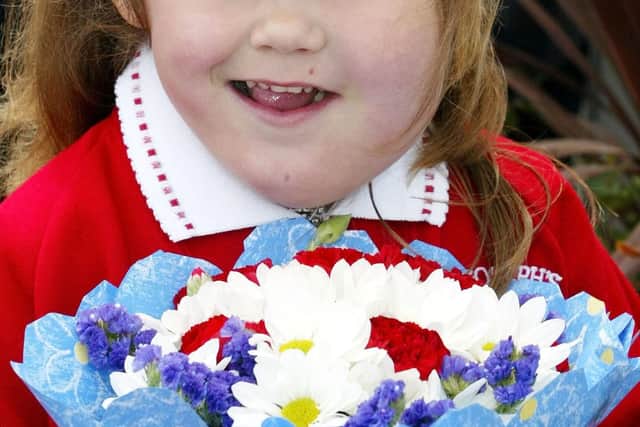 File photo dated 7/5/2002 of Katie Meehan, before presenting Queen Elizabeth II with flowers during her visit to St Josephs RC Primary School, Jarrow, Tyne and Wear. The British social media influencer whose meeting with the Queen aged six made newspaper headlines 20 years ago has said the "wholesome and wonderful experience" showed her she "can do anything". Picture date: Friday September 9, 2022.