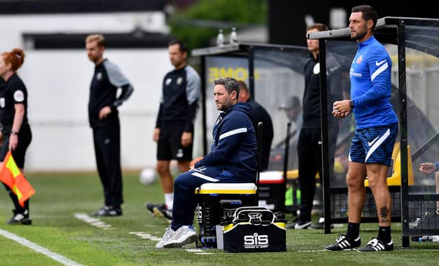 Sunderland boss Lee Johnson watches on at Harrogate
