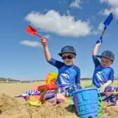 Freddie, 4, and three-year-old Charlie building sandcastles