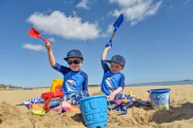 Freddie, 4, and three-year-old Charlie building sandcastles