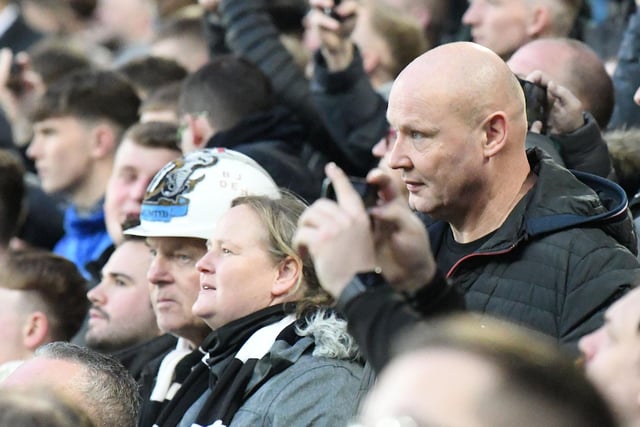 One fan is spotted wearing a Newcastle United themed hard hat