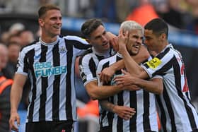 Newcastle player Bruno Guimaraes (2nd r) celebrates his second goal with Sven Botman (l) Fabian Schar and Miguel Almiron (r) during the Premier League match between Newcastle United and Brentford FC at St. James Park on October 08, 2022 in Newcastle upon Tyne, England. (Photo by Stu Forster/Getty Images)