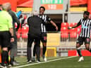 Joe Willock of Newcastle United celebrates with Steve Bruce, Manager of Newcastle United and Allan Saint-Maximin after scoring their side's first goal during the Premier League match between Liverpool and Newcastle United at Anfield on April 24, 2021 in Liverpool, England.