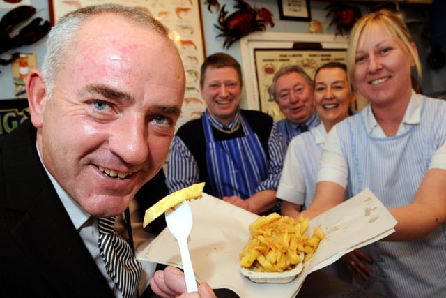 The Mayor, Cllr Ernest Gibson tucks into a bag of chips at Green Lane Fish Shop in 2014, with staff, left to right, David and Brian Pascoe, Joanne Lally and Lynn Fenwick.