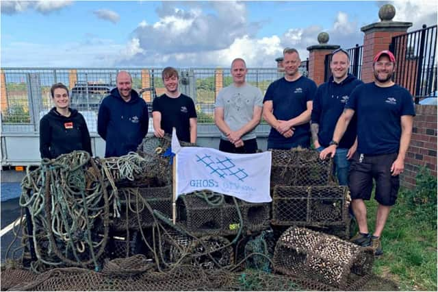 The team of volunteer divers with the retrieved wreckage