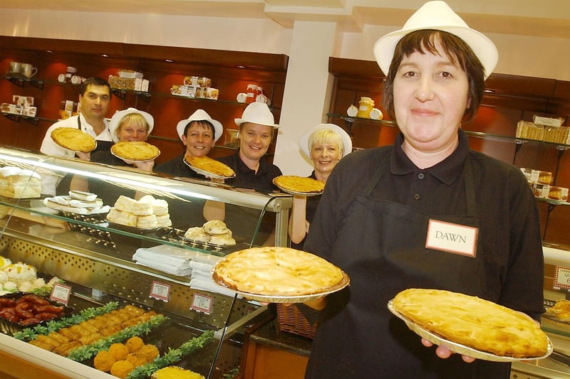 Shop manager Dawn Marshal with her staff and a selection of pies from the Ambry on Church Street.