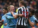 Manchester City striker Erling Haaland clashes with Newcastle United defender Dan Burn.