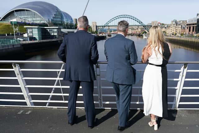 Labour leader Keir Starmer (middle) looks towards the Tyne Bridge with Northumbria Police and Crime Commissioner Kim McGuinness (right) and Newcastle City Council leader Nick Kemp from the Millennium Bridge.