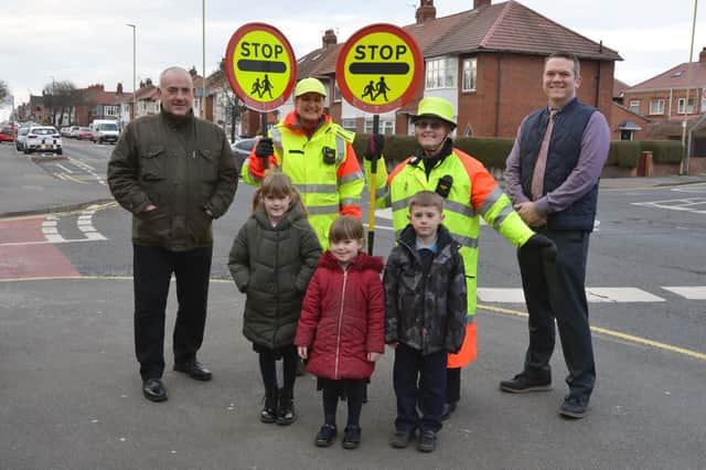 Councillor Ernest Gibson (left) with school crossing patrol staff Wendy Pounder and Edith Mason, Peter Bennett, Mortimer Primary School head teacher, and children Emily, six, Bethany, three, and Dylan, six.