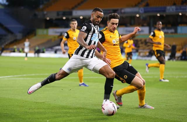 Callum Wilson of Newcastle United has a shot saved whilst Max Kilman of Wolverhampton Wanderers attempts to block during the Premier League match between Wolverhampton Wanderers and Newcastle United at Molineux on October 25, 2020 in Wolverhampton, England.