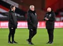 Newcastle United's English head coach Steve Bruce (C) and Assistant Coaches Stephen Clemence (L) and Steve Agnew (R) walk on the pitch ahead of the English Premier League football match between Sheffield United and Newcastle United at Bramall Lane in Sheffield, northern England on January 12, 2021.