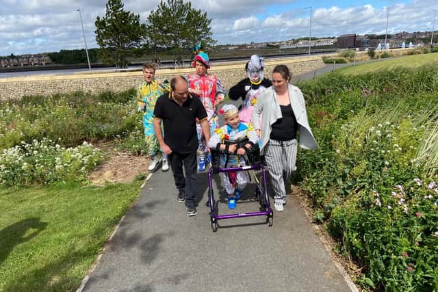 Stephen and his family on the last stretch, with help from his Customs House panto pals.