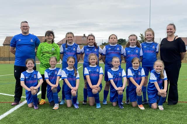 Jarrow U11 Hurricanes FC Manager Steven Scott and players are photographed in their new strip alongside Amy Cooper daughter of kit sponsor Jo Seales. Picture by Frank Reid