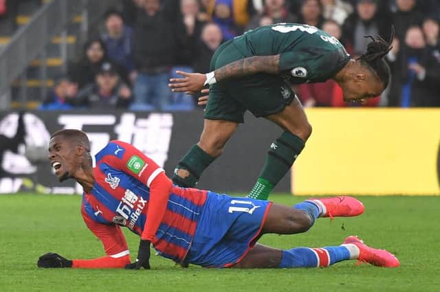 Newcastle United's Austrian midfielder Valentino Lazaro (L) fouls Crystal Palace's Ivorian striker Wilfried Zaha during the English Premier League football match between Crystal Palace and Newcastle United at Selhurst Park in south London on February 22, 2020.
