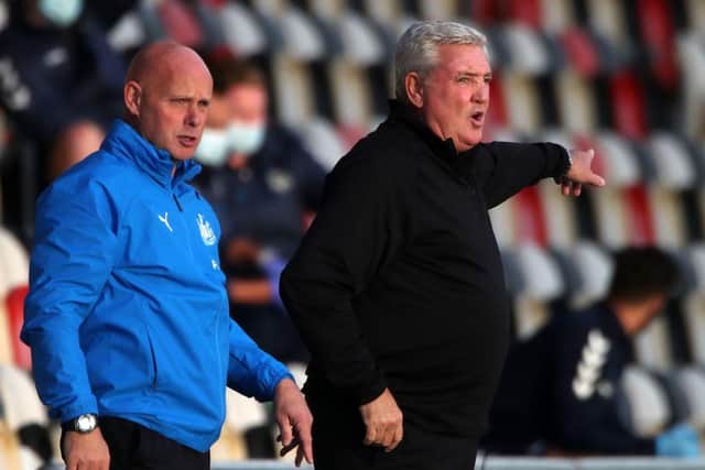 Newcastle United's English head coach Steve Bruce (R) and his Assistant Stephen Agnew (L) look on from the sidelines during the English League Cup fourth round football match between Newport County and Newcastle United at Rodney Parade in Newport, south Wales on September 30, 2020.