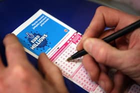Filling out a lottery ticket.