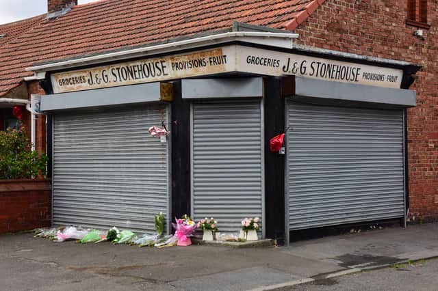 Floral tributes to popular store keeper Gladys Stonehouse, outside her shop in Wood Terrace, Jarrow.