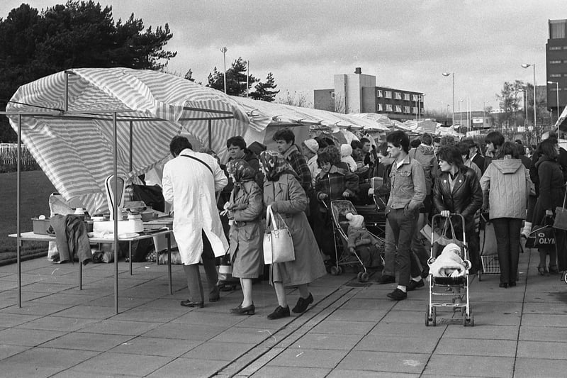 The wind whipped up in this Peterlee market scene from November 1982. Who do you recognise in the photo?