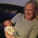 Dawn with her new grandson Roman.