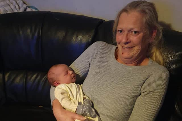 Dawn with her new grandson Roman.