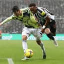 Joe Willock of Newcastle United is challenged by Robin Koch of Leeds United during the Premier League match between Newcastle United and Leeds United at St. James Park on December 31, 2022 in Newcastle upon Tyne, England. (Photo by George Wood/Getty Images)