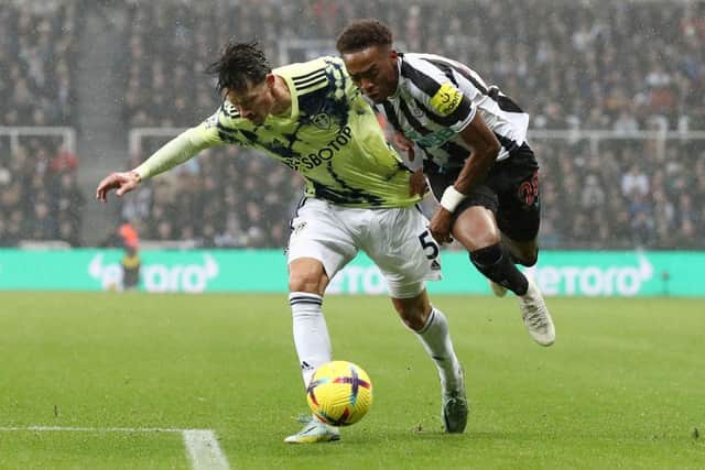 Joe Willock of Newcastle United is challenged by Robin Koch of Leeds United during the Premier League match between Newcastle United and Leeds United at St. James Park on December 31, 2022 in Newcastle upon Tyne, England. (Photo by George Wood/Getty Images)