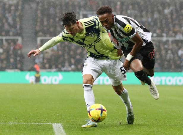 Joe Willock of Newcastle United is challenged by Robin Koch of Leeds United during the Premier League match between Newcastle United and Leeds United at St. James Park on December 31, 2022 in Newcastle upon Tyne, England. (Photo by George Wood/Getty Images)