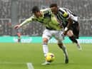 Joe Willock of Newcastle United is challenged by Robin Koch of Leeds United during the Premier League match between Newcastle United and Leeds United at St. James Park on December 31, 2022 in Newcastle upon Tyne, England. (Photo by George Wood/Getty Images)