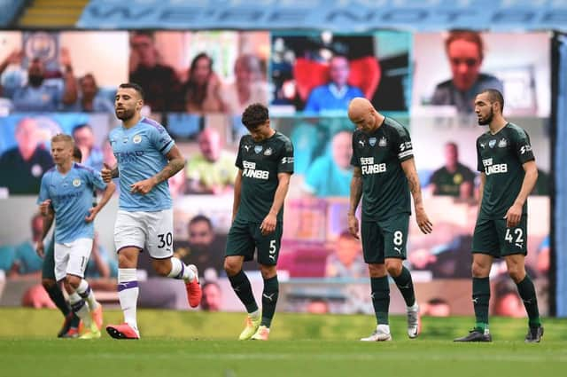 Newcastle United players react to Manchester City's second goal.