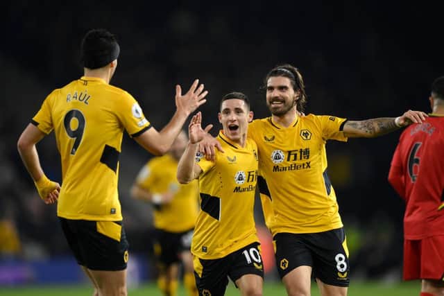 Daniel Podence celebrates with Ruben Neves and Raul Jimenez of Wolverhampton Wanderers after scoring their team's third goal during the Premier League match between Wolverhampton Wanderers and Watford at Molineux on March 10, 2022 in Wolverhampton, England. (Photo by Clive Mason/Getty Images)