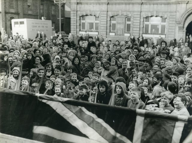 A black and white photograph of children, women and men gathered outside Jarrow Town Hall. Dated on the back, 1960.