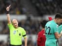 Referee Anthony Taylor shows a red card to Newcastle United's Nick Pope.
