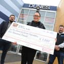 Sarah and Chris Cookson receive a cheque for £1,000 from Dunes Operation Manager Ken Reader, left.