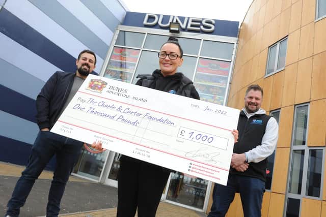 Sarah and Chris Cookson receive a cheque for £1,000 from Dunes Operation Manager Ken Reader, left.