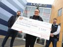 Sarah and Chris Cookson receive a cheque for £1,000 from Dunes Operation Manager Ken Reader, left.
