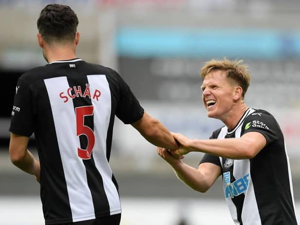 Matt Ritchie celebrates with Fabian Schar.